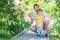 Father and son playing together outdoors in summer day: dad and child are launching toy airplane. New start, parental help concept