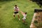 Father and son playing water gun fight outdoors.