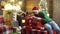 Father and son prepare at Christmas. Dad and child hold Xmas prasent gifts at home. Kid with parent giving presents and