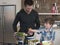 Father And Son Preparing Salad At Kitchen Counter