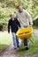 Father and son pushing wheelbarrow