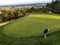A father and son on a putting green playing golf surrounded by beautiful scenery outside of Victoria, British Columbia, Canada.
