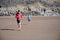 Father and son racing on the beach