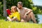 Father and son reading book in park, man encourages boy to knowledge, family education. Father and child read book