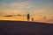 Father and son at the red desert at dawn. Traveling with children concept