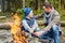 Father and son roasting marshmallow over campfire