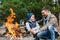 Father and son roasting marshmallow over campfire