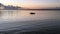 Father and son in a rowboat. Silhouettes of two people boating at sunset.