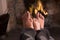 Father and son\'s Feet warming at a fireplace