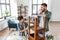 father and son sanding old table with sponge