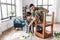 father and son sanding old table with sponge