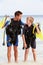 Father And Son With Scuba Diving Equipment On Beach Holiday