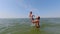 Father and son at sea on a sunny day. Slowmotion. Family vacation at sea, water games