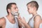 Father and son shaving together