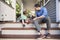 Father And Son Sit On Porch Of House Playing With Toys Together