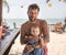 father and son sitting at beach bar counter and require the drinks