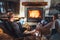 Father with son sitting in comfortable armchairs in their cozy country house near fireplace and enjoying a warm atmosphere and