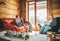 Father and son sitting on cozy couches in living room and reading. Family spending holiday time in country house concept image.