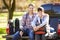 Father And Son Sitting In Pick Up Truck On Camping Holiday