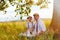 Father and son sitting under an old oak tree