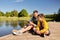 father and son with smartphone on river berth