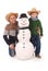 Father and son with snowman with scarf and hat