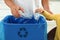 Father and son sorting garbage in kitchen. Recycling concept