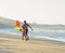 Father with son, sunset at the seacoast with kite, happy family