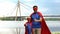 Father and son in superhero costumes showing thumbs up, motivation and teamwork