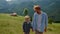 Father son talking outdoors walking mountain slope closeup. Family leisure.