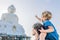 Father and son tourists on the Big Buddha statue. Was built on a high hilltop of Phuket Thailand Can be seen from a