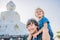 Father and son tourists on the Big Buddha statue. Was built on a high hilltop of Phuket Thailand Can be seen from a