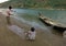 A father and a son untangling a fishing net before going fishing in the river