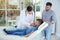 Father and son visiting pediatrician. Doctor working with patient