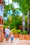 Father and son walking on cute tropical street