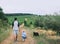 Father and son walking with dog on nature, outdoors.