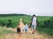 Father and son walking with dog on nature, outdoors.