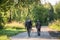 Father and son walking together outdoors with rifle for hunting