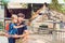 Father and son watching and feeding giraffe in zoo. Happy kid ha