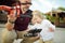 Father and son watching and navigating a drone. Cute toddler boy helping his father to operate a drone by remote control