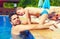 Father and son watching at pretty chicks in swimming pool, during summer vacation