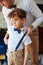 Father And Son Wearing Matching Outfits Getting Ready For Wedding At Home