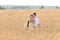 Father and son are in the wheat field. Ukrainian family. Father`s day. Boy with father. Day of Independence