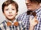 Father with son in wooden bowties plaid shirt