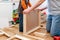 Father and son working on assembling flat-pack furniture for boy`s room.