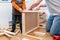 Father and son working on assembling flat-pack furniture for boy`s room.