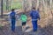 Father and Sons Hiking Through Forest