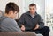 Father soothes teenager son after quarrel