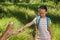 Father spraying tick repellent on his little daughter`s arm during hike in nature