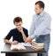 Father standing near son\'s desk helping him doing his homework